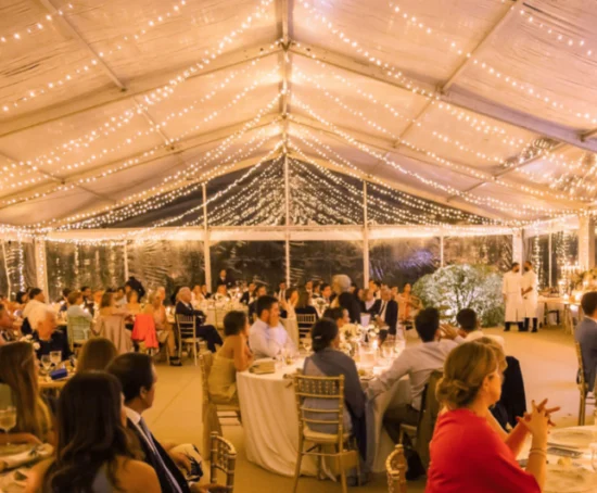 Interior de carpa a dos aguas para boda con luces decorativas